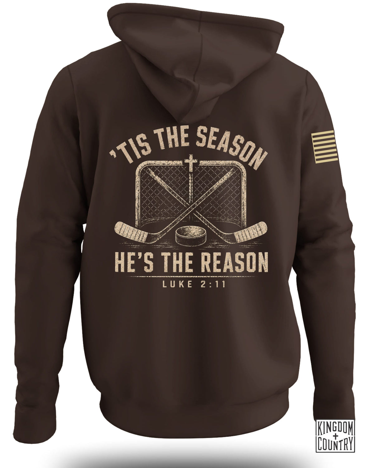 Brown hooded sweatshirt viewed from the back, featuring a distressed hockey graphic and the text "Tis The Season He's The Reason Luke 2:11."
