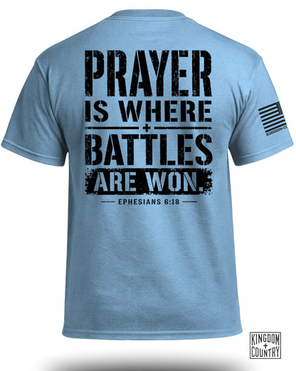 Light blue t-shirt with distressed black text: "Prayer Is Where Battles Are Won. Ephesians 6:18".