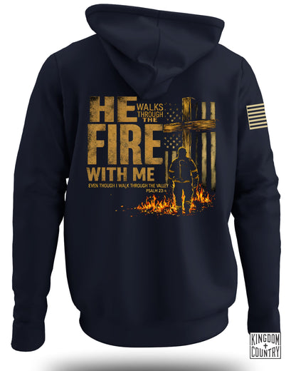 Dark blue hoodie with "He Walks Through The Fire With Me" text and firefighter graphic.