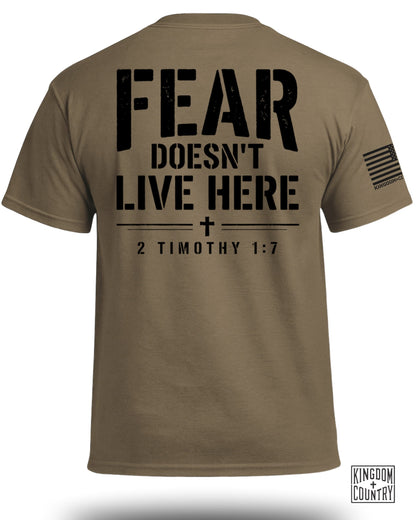 Brown t-shirt with "FEAR DOESN'T LIVE HERE 2 TIMOTHY 1:7" text and flag.
