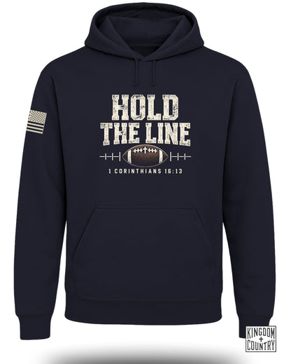 Navy hoodie with "HOLD THE LINE" text, football, and "1 Corinthians 16:13".