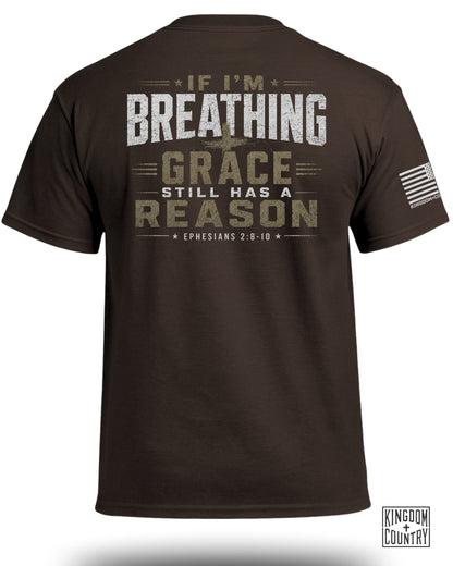 Brown t-shirt with distressed text "IF I'M BREATHING GRACE STILL HAS A REASON" and scripture reference.