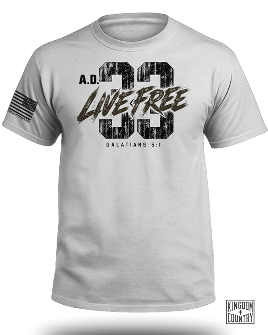 Light gray crewneck t-shirt featuring a distressed A.D. 33 Live Free Galatians 5:1 graphic on the chest.