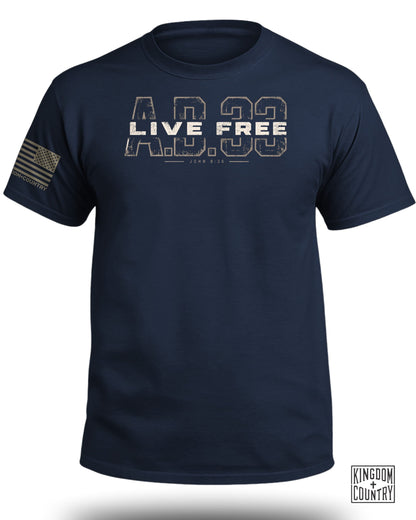 Dark blue short-sleeve t-shirt with distressed "AD 33 Live Free" text and an American flag patch on the sleeve.