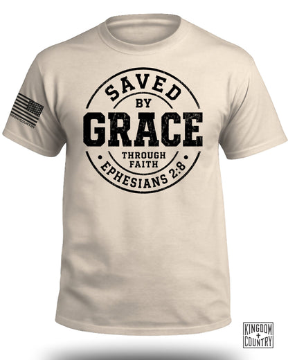 Cream t-shirt with "Saved by Grace Through Faith Ephesians 2:8" text and American flag logo.