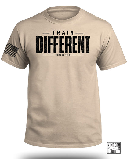 Tan t-shirt with "TRAIN DIFFERENT ROMANS 12:2" and American flag graphic.