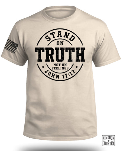 T-shirt with black print: "STAND ON TRUTH NOT ON FEELINGS JOHN 17:17". American flag on sleeve.