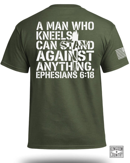 Green t-shirt with white text: "A man who kneels can stand against anything. Ephesians 6:18"