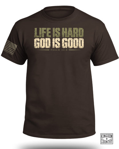 Brown t-shirt with "LIFE IS HARD GOD IS GOOD PSALM 34:8" text.