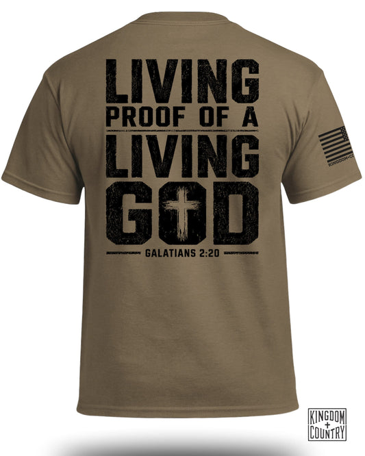 Tan t-shirt with black distressed text "LIVING PROOF OF A LIVING GOD GALATIANS 2:20" and American flag.