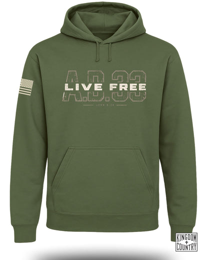 An olive green hoodie featuring a front pocket, drawstring hood, and large text reading LIVE FREE A.D. 33.