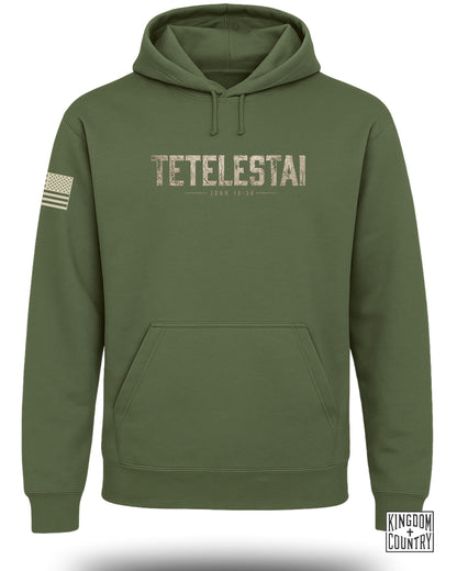 Green hoodie with "TETEL ESTAI" and "JOHN 19:30" text, and US flag.
