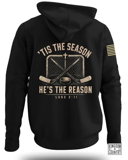 Back view of a black hooded sweatshirt with text, a hockey net, crossed sticks, and a puck.