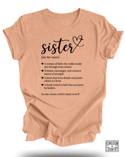 Peach t-shirt with "sister [sis-ter noun]" definition and Kingdom Country logo.