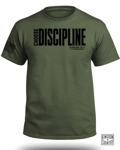 Olive green t-shirt with black "CHOOSE DISCIPLINE HEBREWS 12:11" text and US flag sleeve patch.