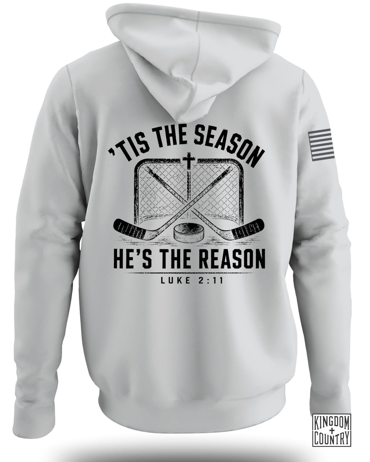 Back view of a white hooded sweatshirt featuring a black graphic of crossed hockey sticks, a net, a puck, and the text "'Tis the Season, He's the Reason, Luke 2:11."
