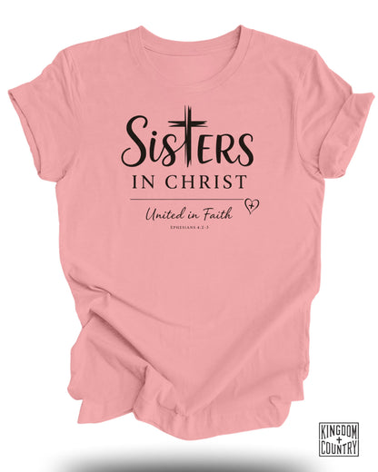 Pink t-shirt with "Sisters in Christ" and "United in Faith" text.