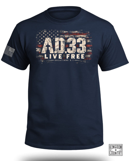 Navy blue crewneck t-shirt featuring a distressed American flag graphic, AD 33, and Live Free text.