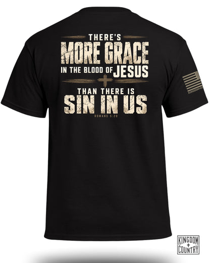 Black t-shirt displaying religious text on the back and an American flag patch on the sleeve.