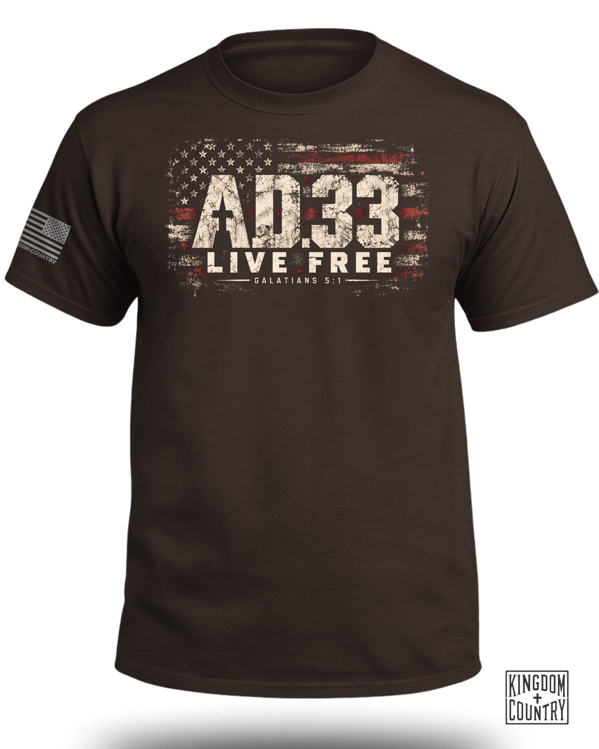 A dark brown crewneck t-shirt featuring a distressed American flag graphic, the text AD 33, Live Free, and Galatians 5:1.