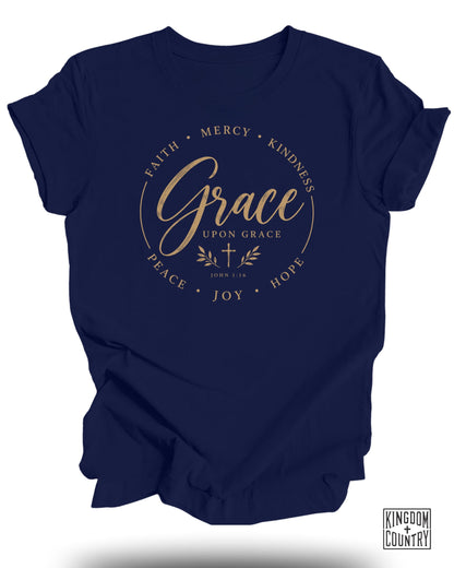 Navy t-shirt with "Grace Upon Grace" and "John 1:16" text, surrounded by Faith, Mercy, Kindness, Hope, Joy, Peace.