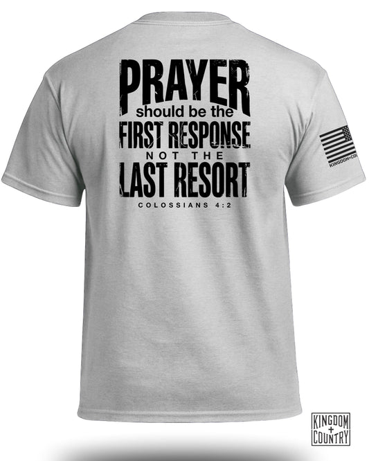 Gray t-shirt with "PRAYER should be the FIRST RESPONSE NOT THE LAST RESORT COLOSSIANS 4:2" and a flag.