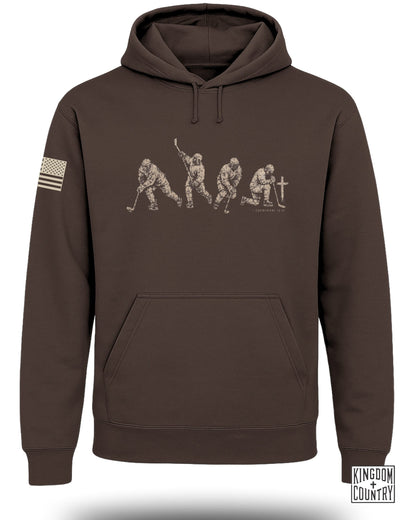 Brown hoodie with faded hockey player graphic and 1 Corinthians 10:31 text.