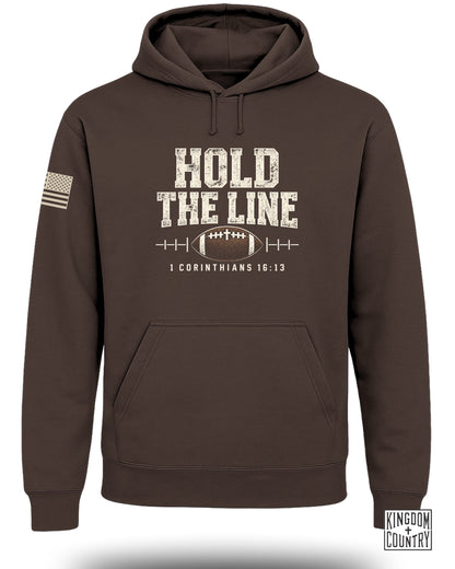 Brown hoodie with "HOLD THE LINE" text, football, and 1 Corinthians 16:13.