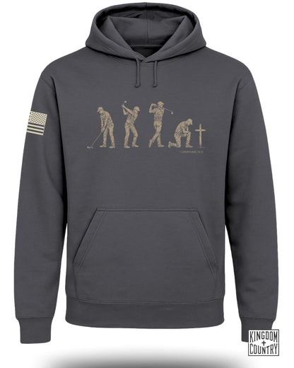 Dark gray hoodie with graphic of golfer's evolution and cross with scripture.