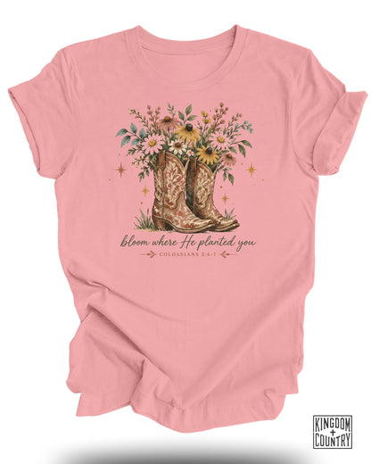 Pink t-shirt with cowboy boots filled with flowers and text "bloom where He planted you".