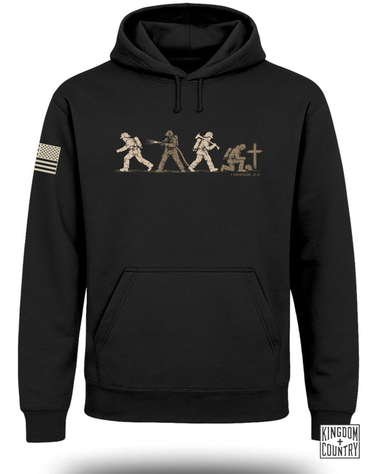 Black hooded sweatshirt with a firefighter graphic on the chest and an American flag patch on the sleeve.
