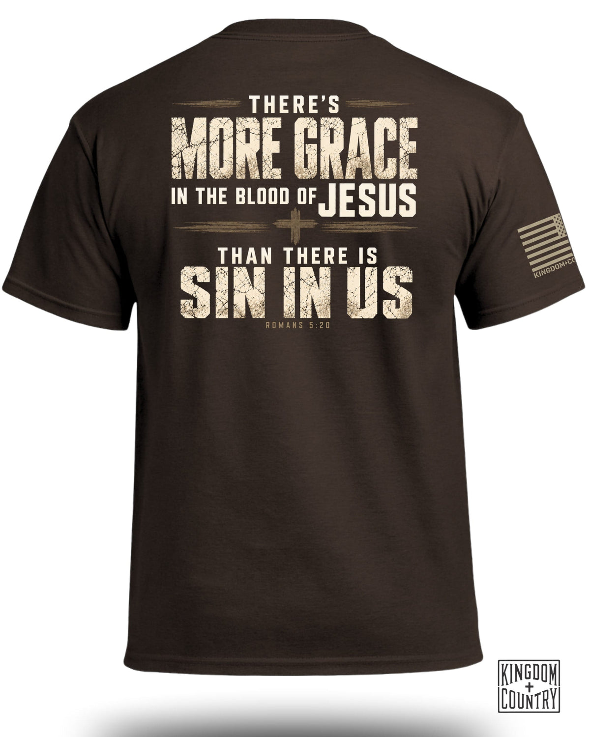 Brown t-shirt viewed from the back, featuring distressed religious text and a small flag on the sleeve.