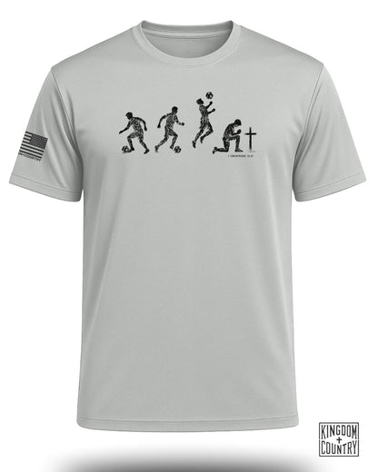 T-shirt graphic of soccer players in progression with a cross and "1 Corinthians 10:31".