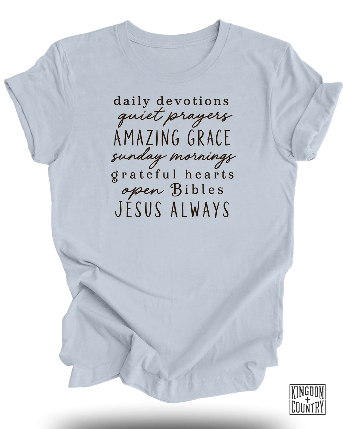 Light blue t-shirt with black text: daily devotions, quiet prayers, amazing grace, sunday mornings, grateful hearts, open bibles, Jesus always.