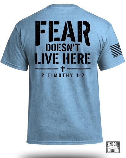 Light blue t-shirt with black text: "FEAR DOESN'T LIVE HERE 2 TIMOTHY 1:7".
