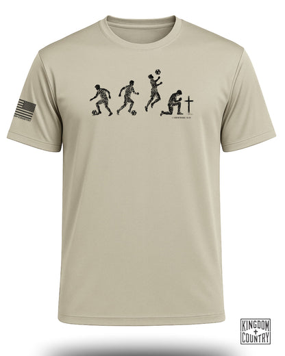 T-shirt with black soccer player evolution graphic and "KINGDOM COUNTRY" logo.