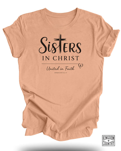 Peach t-shirt with "Sisters in Christ" and "United in Faith" text.
