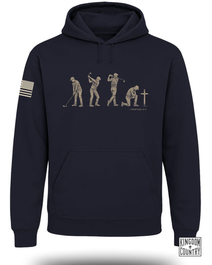 Navy hoodie with graphic of golfer's evolution and cross, 1 Corinthians 10:31