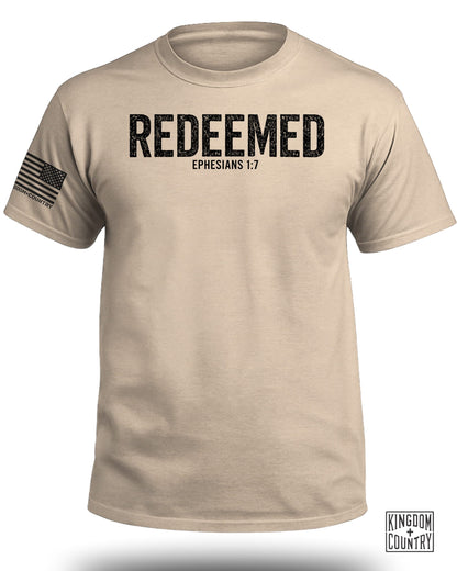 Tan t-shirt with "REDEEMED EPHESIANS 1:7" and American flag graphic.