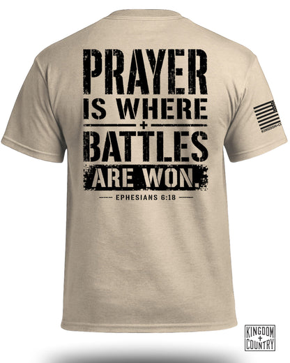 Tan t-shirt with black text: "PRAYER IS WHERE BATTLES ARE WON. EPHESIANS 6:18."