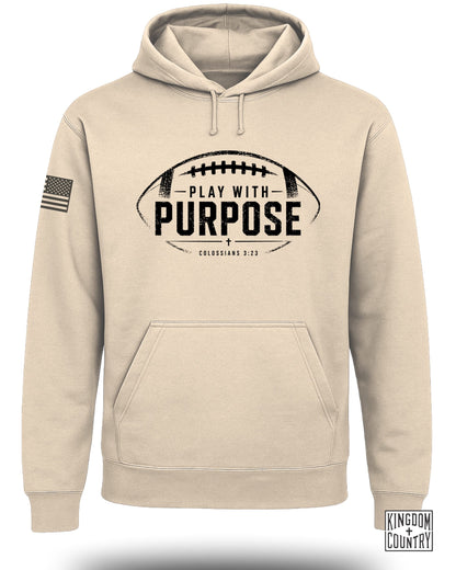 Tan hooded sweatshirt with American flag on sleeve and "Play With Purpose" text.