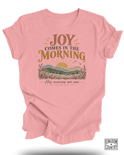 Pink t-shirt with "Joy Comes in the Morning" and "His Mercies Are New Psalm 30:5" text.