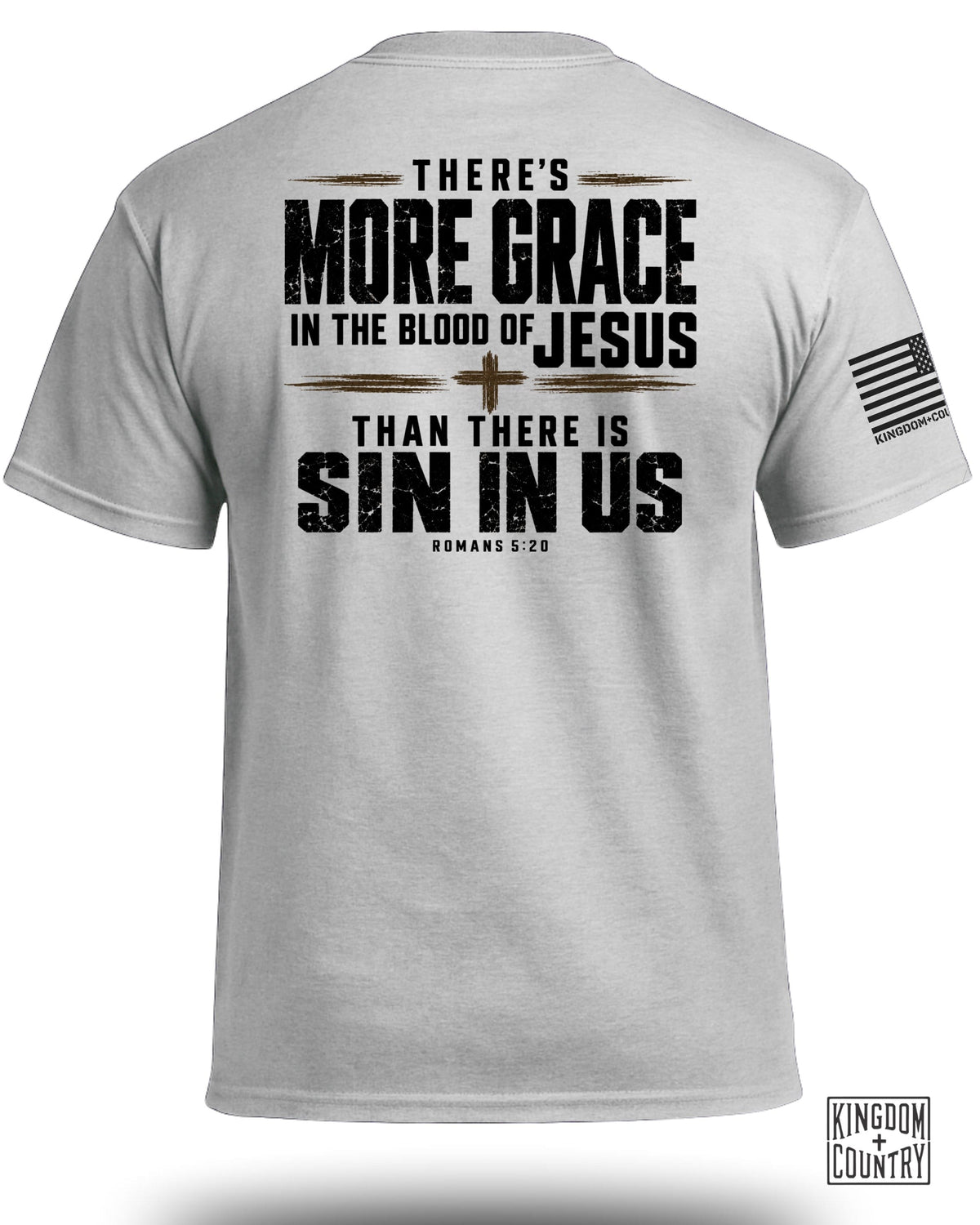 A light gray t-shirt displays text on the back that reads, THERE'S MORE GRACE IN THE BLOOD OF JESUS THAN THERE IS SIN IN US ROMANS 5:20 with a small cross symbol.