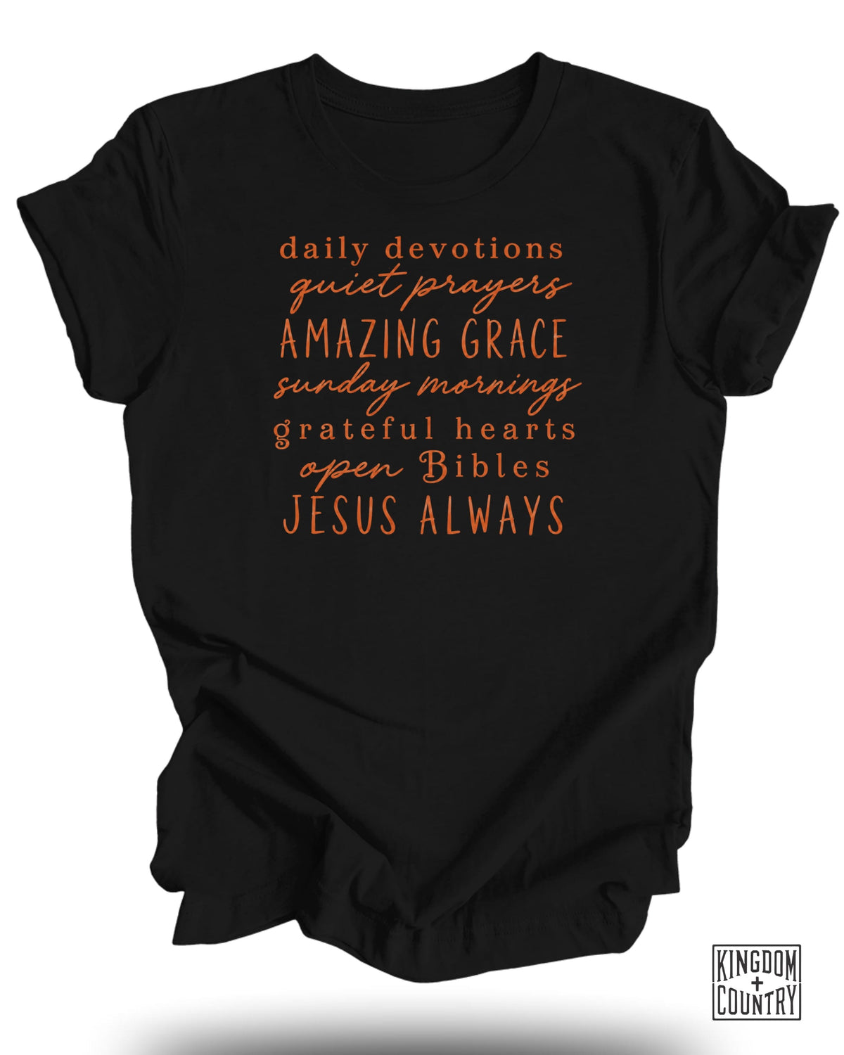 Black t-shirt with orange text reading "daily devotions quiet prayers AMAZING GRACE sunday mornings grateful hearts open Bibles JESUS ALWAYS".