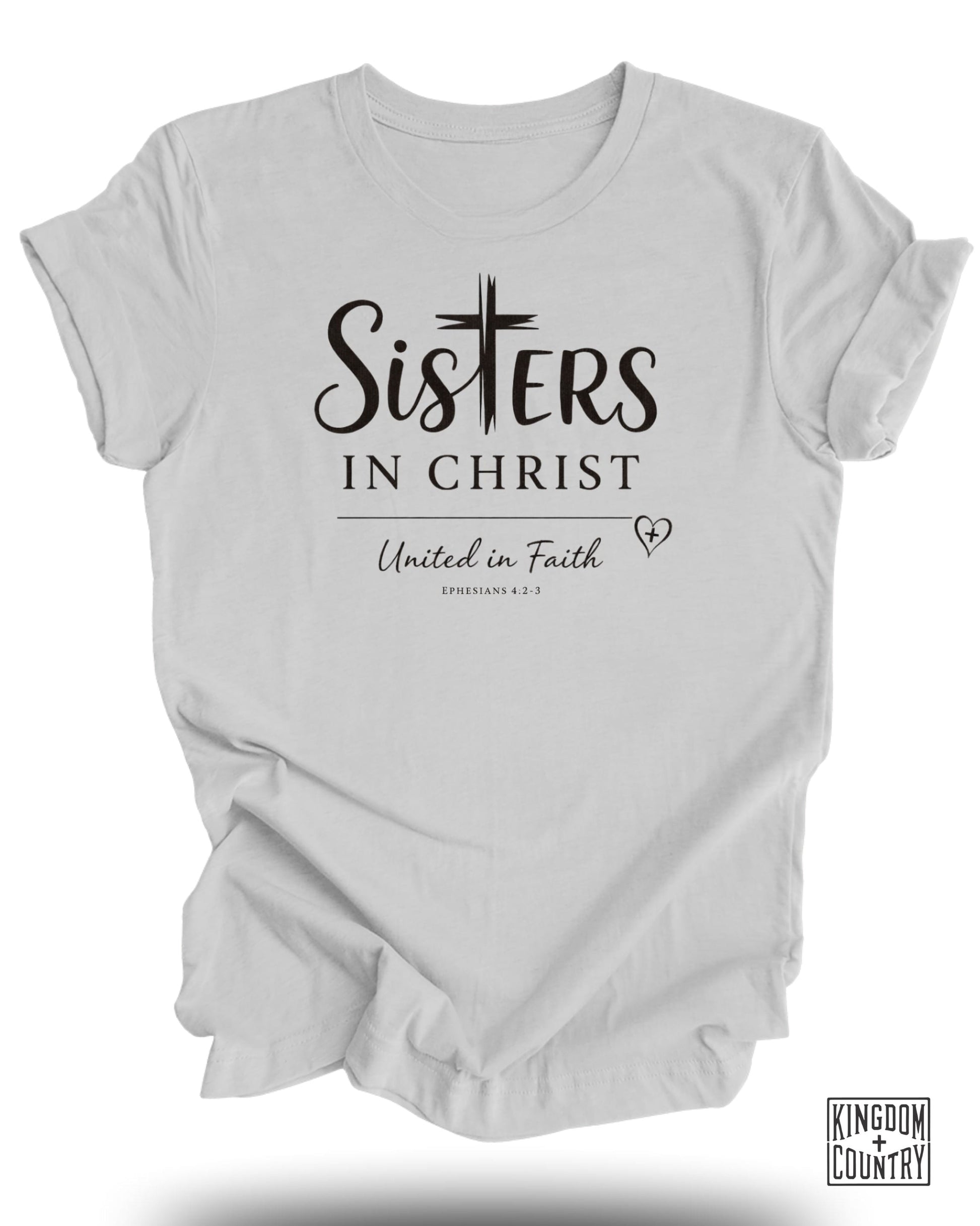 White t-shirt with "Sisters in Christ United in Faith" and "Ephesians 4:2-3" text.
