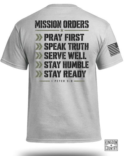 Gray t-shirt with "MISSION ORDERS: PRAY FIRST, SPEAK TRUTH, SERVE WELL, STAY HUMBLE, STAY READY" and "1 PETER 5:8".