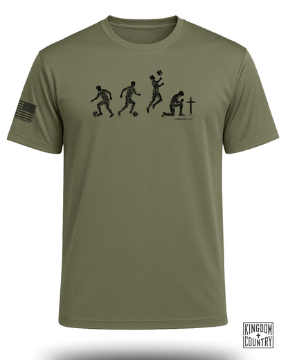 Olive green t-shirt with graphic of soccer player evolution and Bible verse.