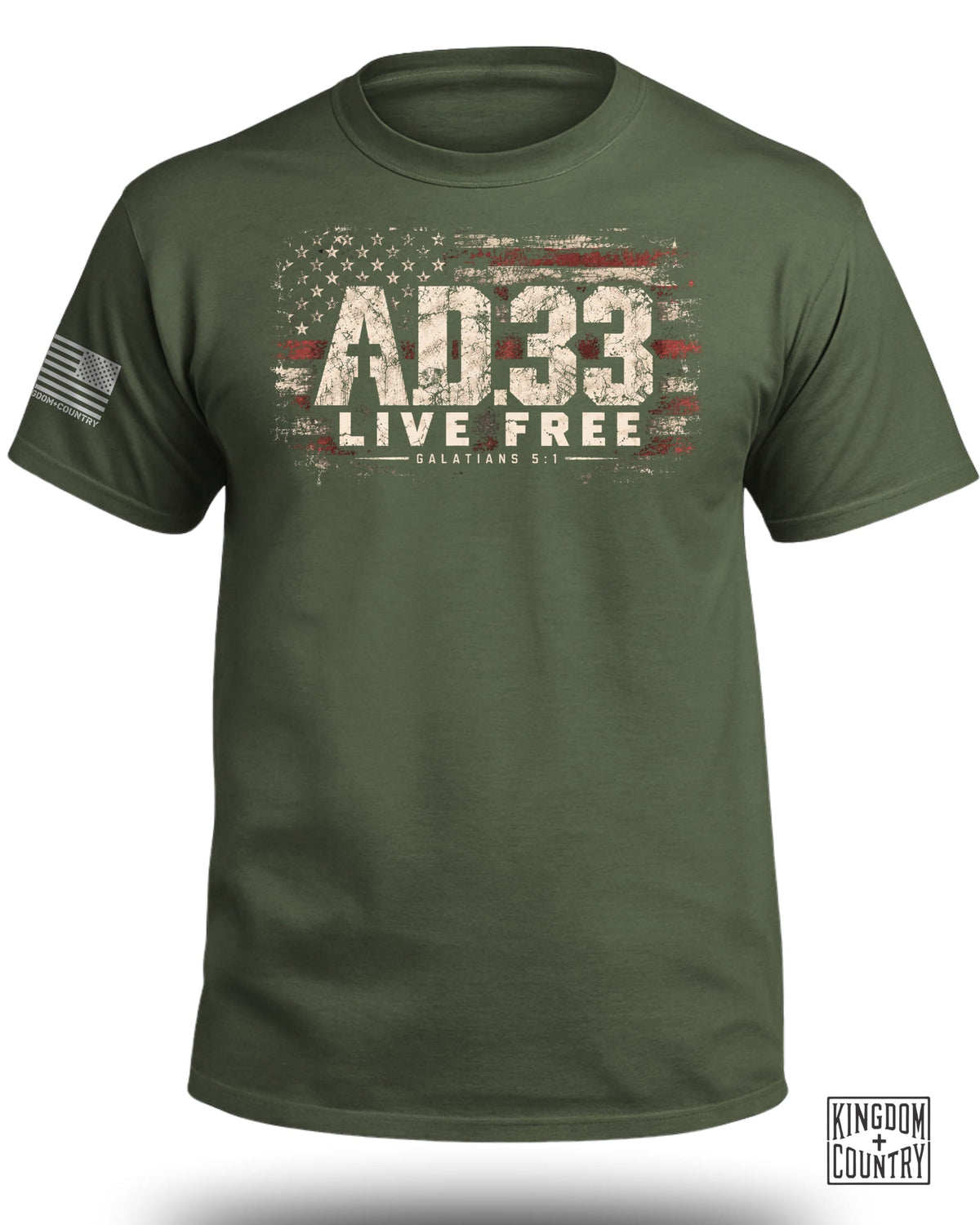 An olive green t-shirt featuring a distressed American flag graphic, the text AD.33 LIVE FREE, and Galatians 5:1.