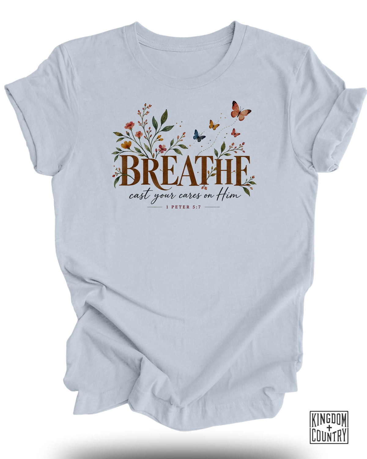 Light blue t-shirt with "BREATHE cast your cares on Him" and Bible verse 1 Peter 5:7.