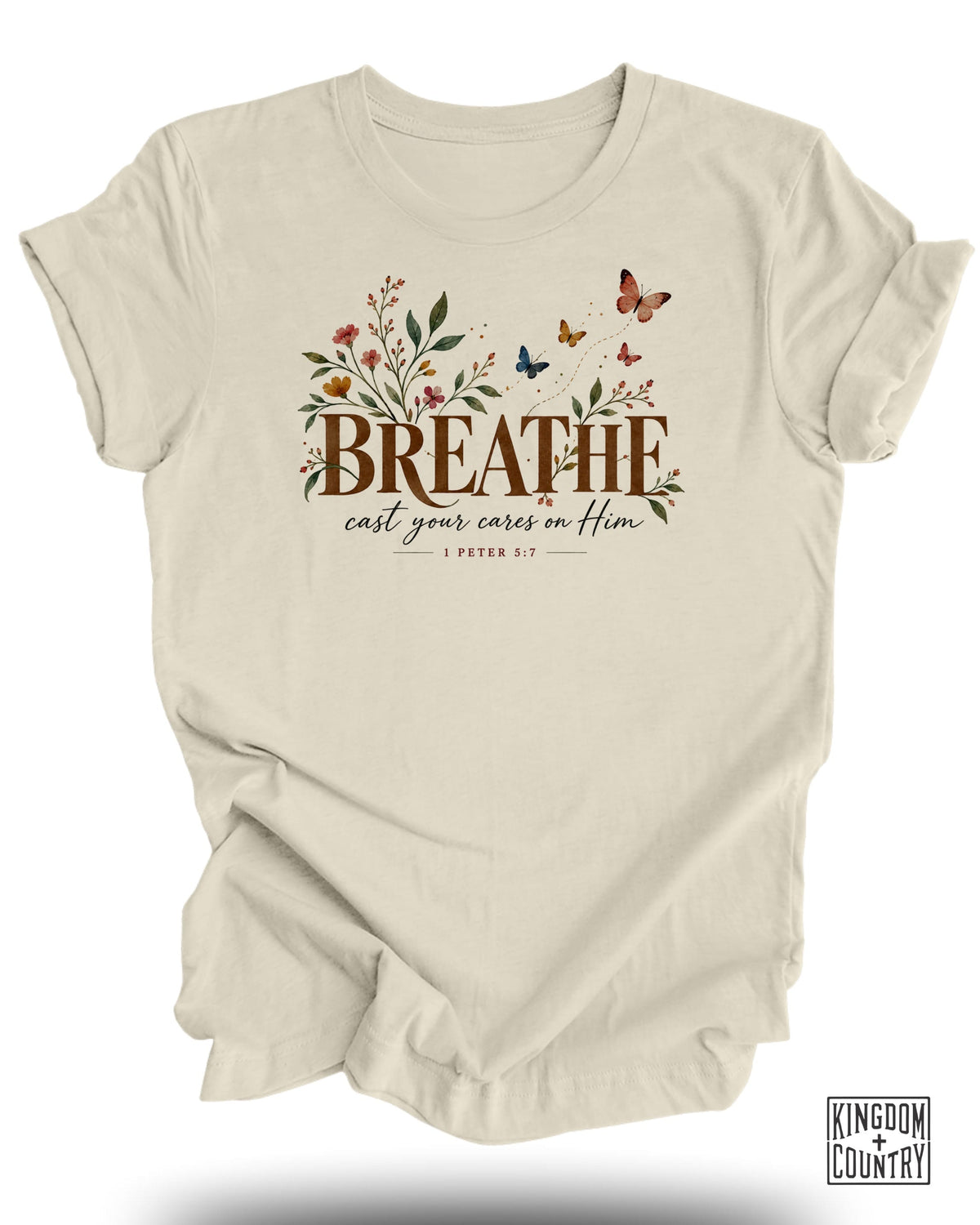 Cream t-shirt with "BREATHE cast your cares on Him" text and floral butterfly design.